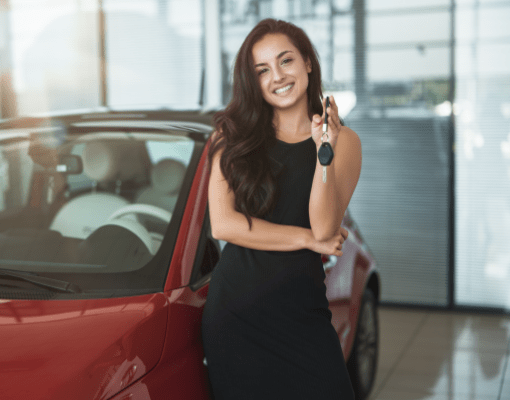 Woman standing in front of car with car keys