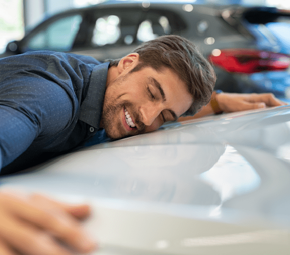 Man Hugging Hood of Car